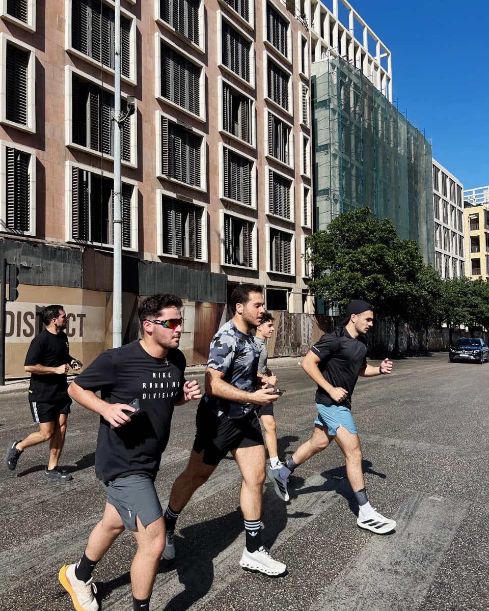 Three Run Club Beirut runners mid-stride through a Beirut street in daylight